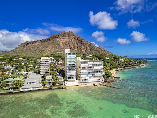 birds eye view of property with a water and mountain view