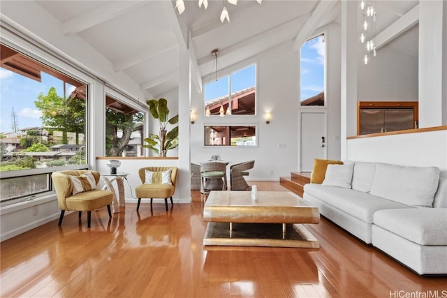 sunroom with lofted ceiling with beams and a healthy amount of sunlight