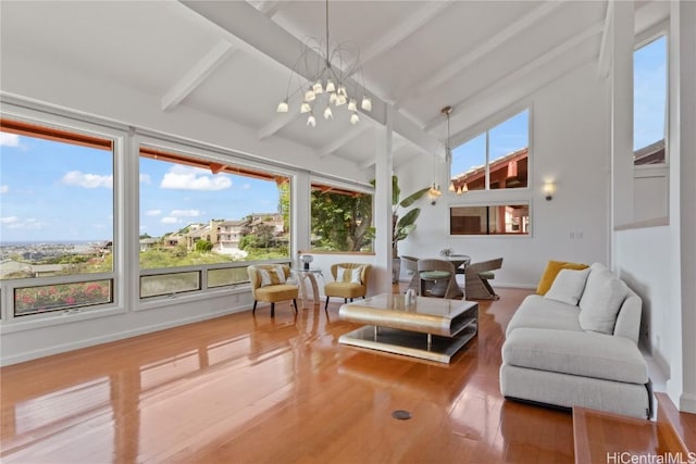 sunroom / solarium featuring beamed ceiling and a notable chandelier