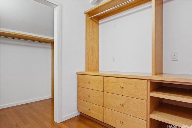 walk in closet featuring light hardwood / wood-style floors