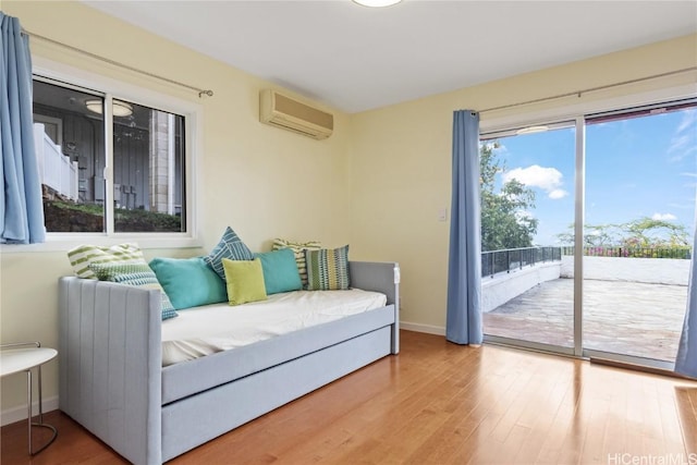 interior space featuring radiator heating unit, plenty of natural light, and an AC wall unit