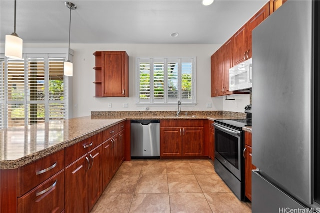 kitchen with pendant lighting, sink, appliances with stainless steel finishes, light tile patterned flooring, and kitchen peninsula