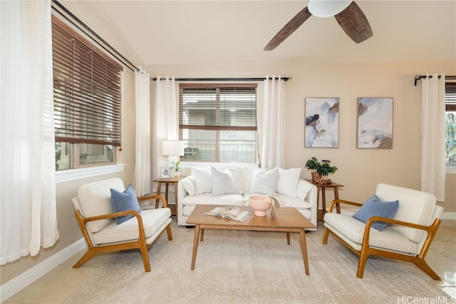 sitting room with ceiling fan and light tile patterned flooring