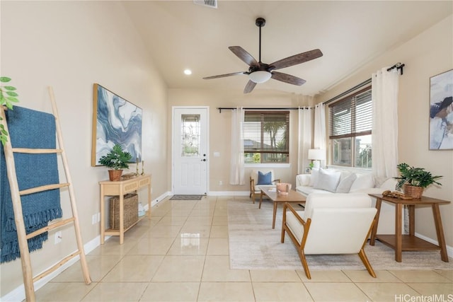 sitting room featuring ceiling fan, light tile patterned flooring, and lofted ceiling