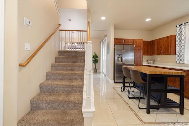 kitchen with stainless steel fridge and light tile patterned floors