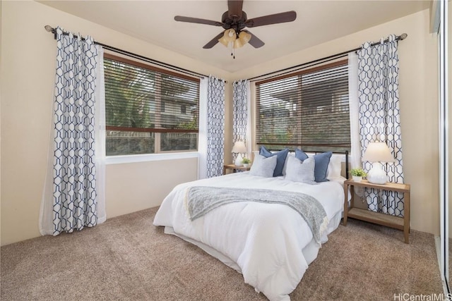 bedroom featuring ceiling fan and light carpet