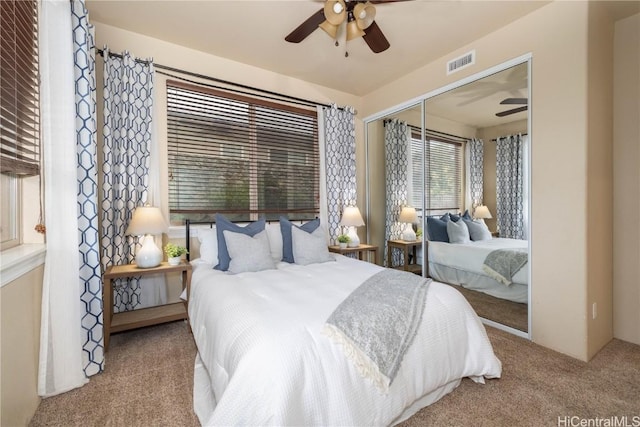 carpeted bedroom with a closet and ceiling fan