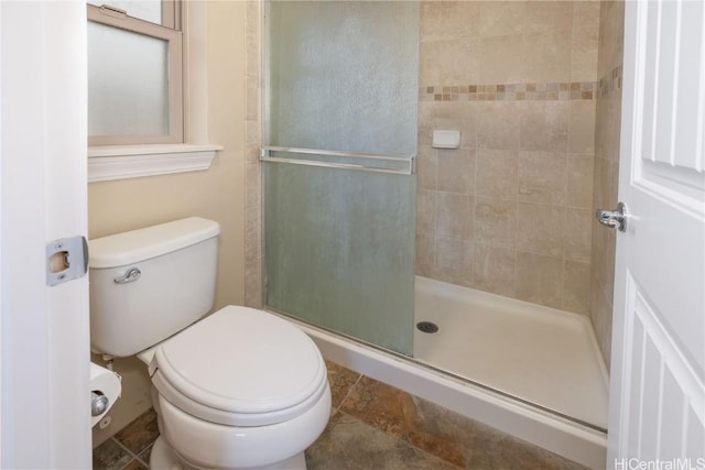 bathroom with walk in shower and toilet