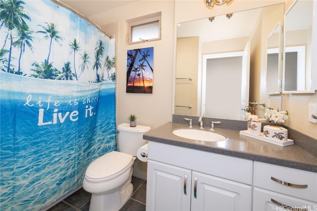 bathroom with tile patterned floors, vanity, and toilet