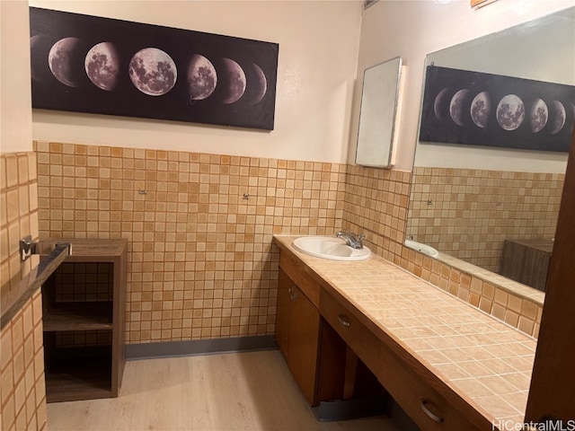 bathroom with vanity, tile walls, and wood-type flooring