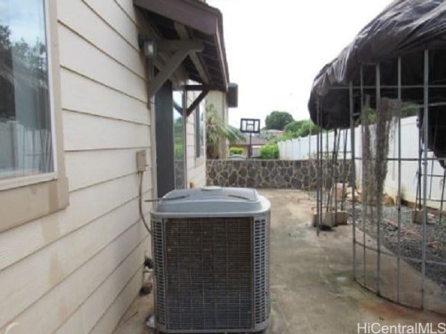 exterior details with concrete floors, wood walls, and central air condition unit