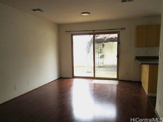 unfurnished room featuring dark hardwood / wood-style flooring