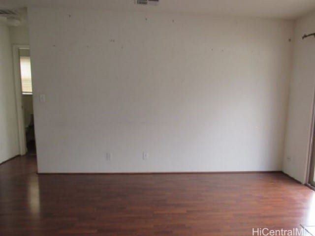 empty room with dark wood-type flooring