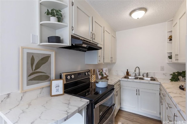 kitchen featuring sink, light stone countertops, a textured ceiling, stainless steel electric range oven, and white cabinetry