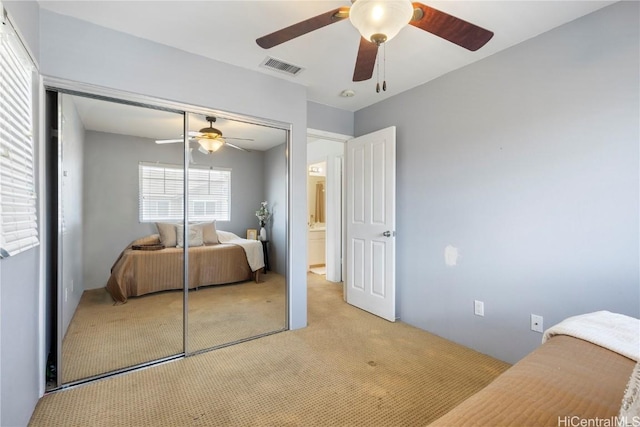 carpeted bedroom featuring ceiling fan and a closet