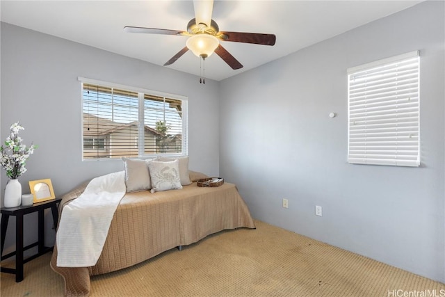 bedroom featuring ceiling fan and light colored carpet