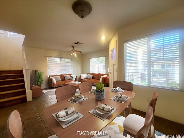 dining area featuring tile patterned floors and ceiling fan