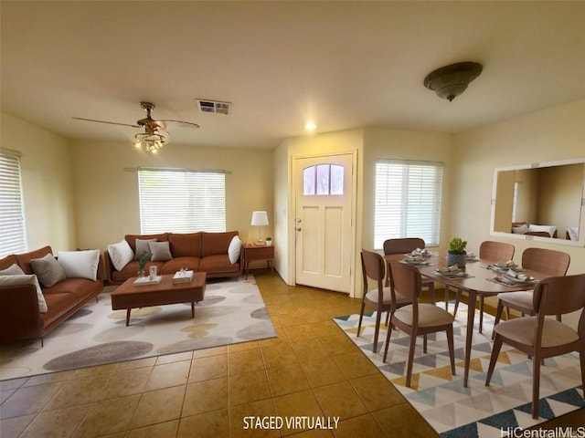 living room with ceiling fan and light tile patterned floors