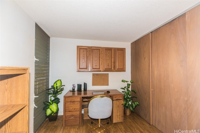 office with light hardwood / wood-style floors and a textured ceiling