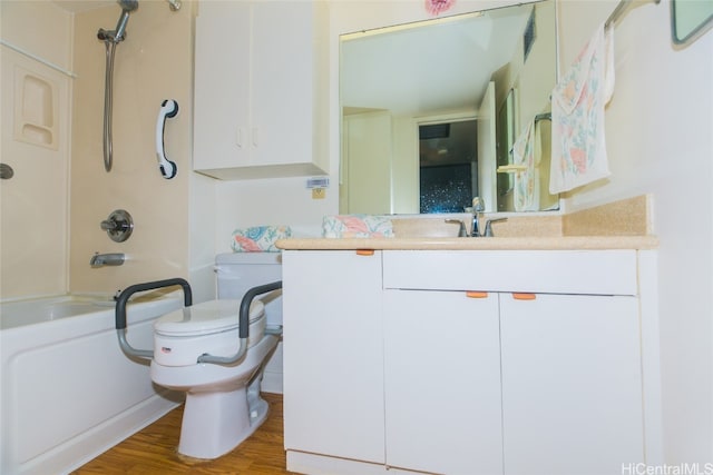 full bathroom featuring hardwood / wood-style flooring, vanity, toilet, and washtub / shower combination