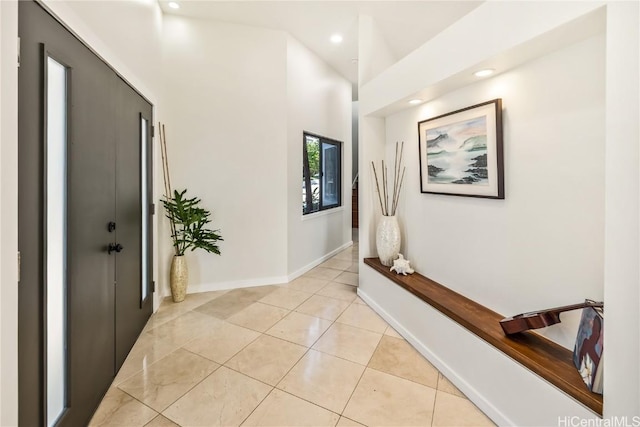 hall featuring light tile patterned floors