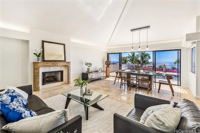 living room featuring a fireplace, light tile patterned floors, and vaulted ceiling