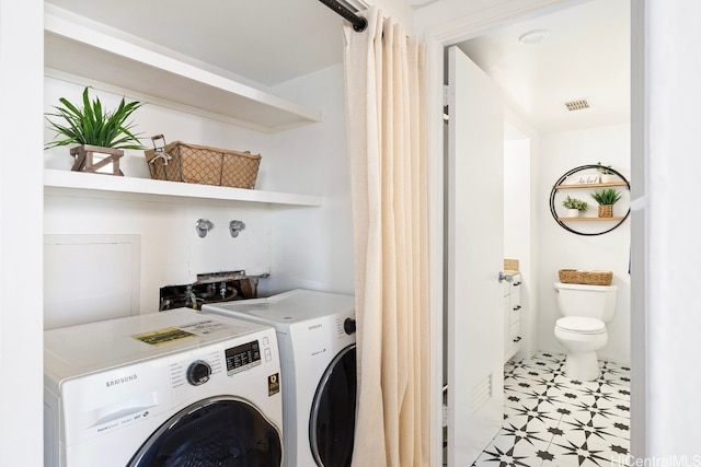 clothes washing area with light tile patterned flooring and washing machine and dryer