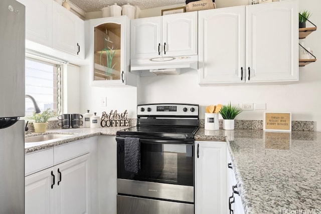 kitchen with white cabinets, a textured ceiling, and appliances with stainless steel finishes