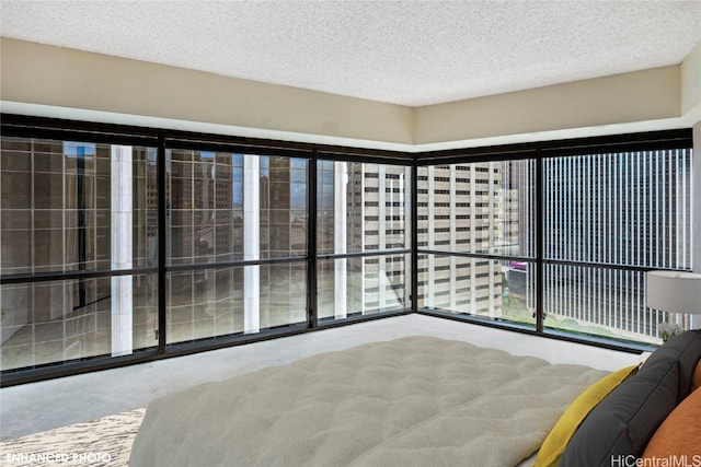 unfurnished bedroom featuring a textured ceiling and a wall of windows