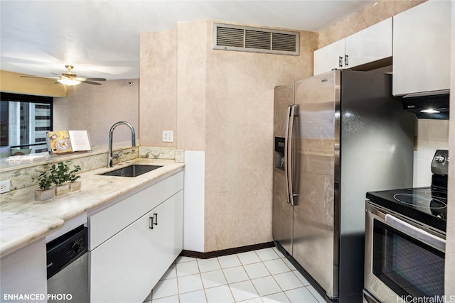 kitchen with white cabinetry, sink, ventilation hood, light tile patterned floors, and appliances with stainless steel finishes