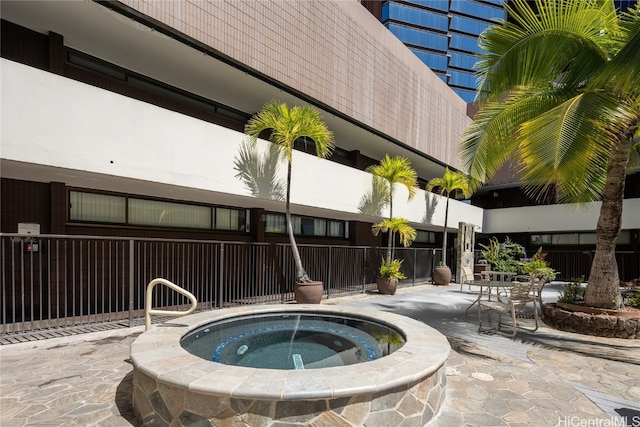 view of pool featuring a community hot tub and a patio area