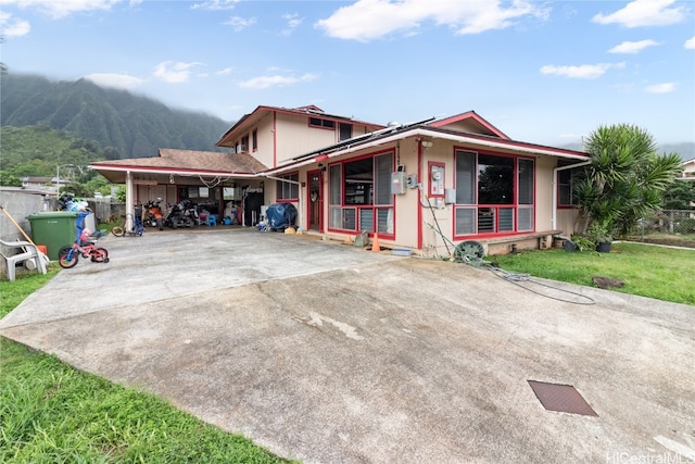 view of front of property featuring a carport and a mountain view