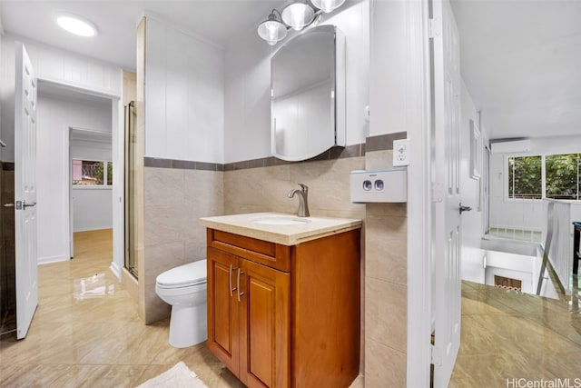 bathroom with an AC wall unit, toilet, a shower with door, vanity, and tile walls