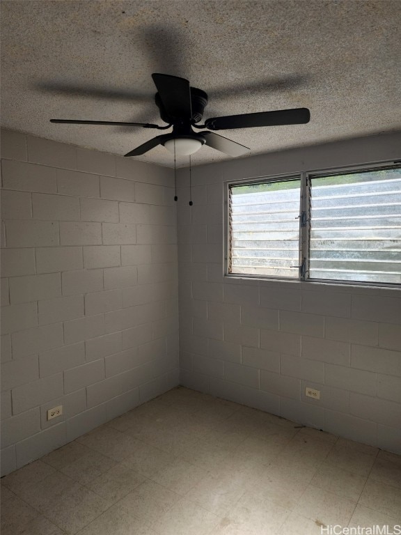 spare room with ceiling fan and a textured ceiling