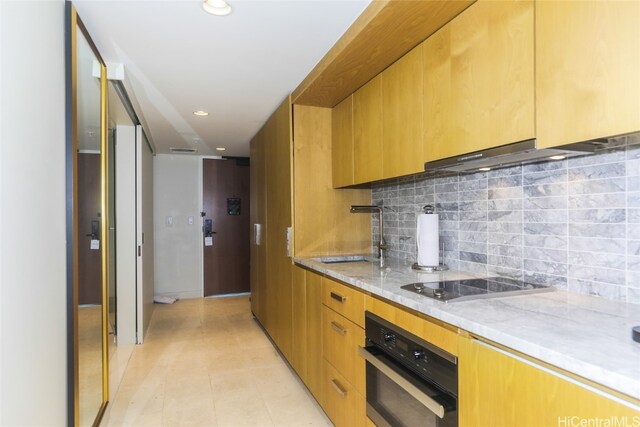 kitchen featuring oven, sink, decorative backsplash, light tile patterned floors, and cooktop