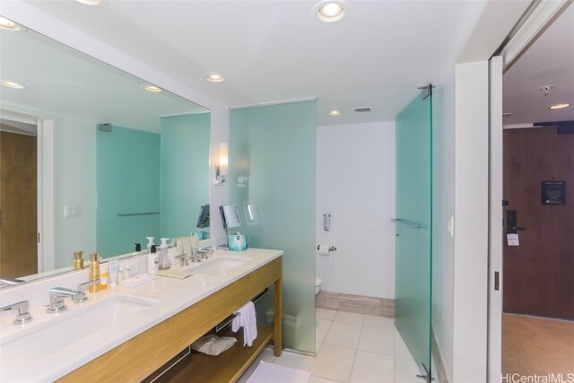 bathroom featuring tile patterned flooring, vanity, and toilet