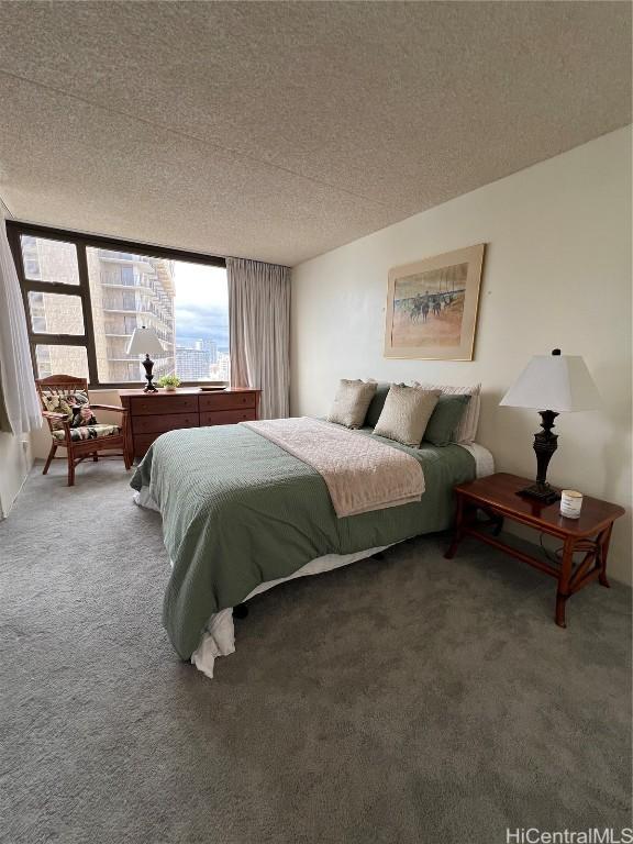 carpeted bedroom featuring a textured ceiling