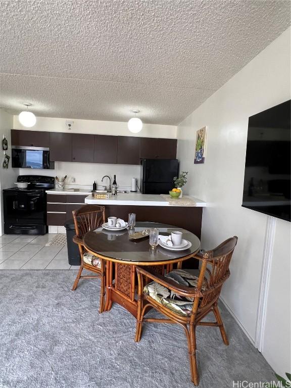 dining space with light tile patterned floors and sink