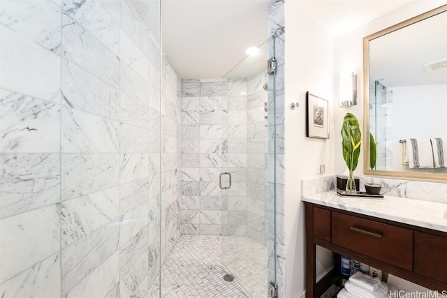 bathroom with vanity and a shower with door