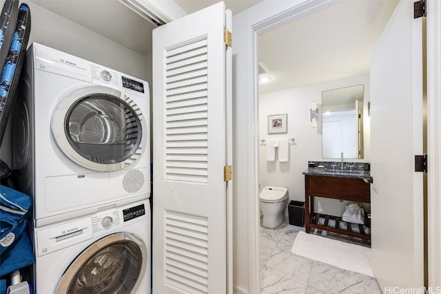 laundry room featuring sink and stacked washer and dryer