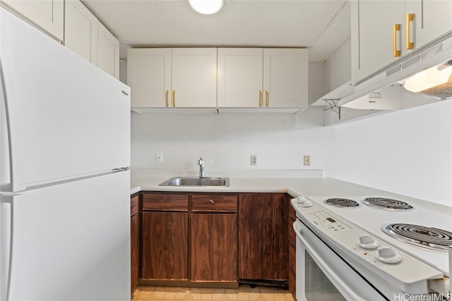 kitchen featuring a textured ceiling, sink, white cabinets, and white appliances