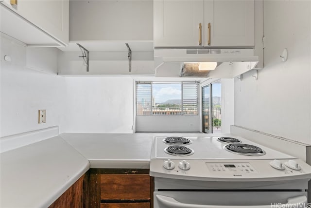 kitchen featuring white cabinets and white electric stove