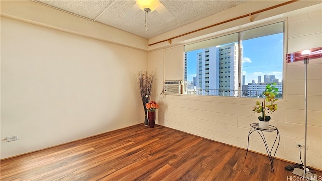 spare room with hardwood / wood-style flooring and ceiling fan