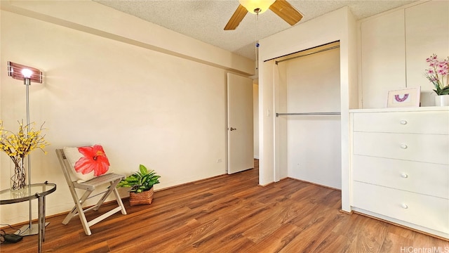 unfurnished room featuring wood-type flooring, a textured ceiling, and ceiling fan