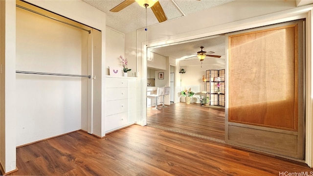 interior space with wood-type flooring and a textured ceiling