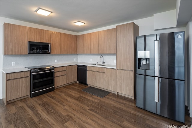 kitchen with tasteful backsplash, sink, stainless steel appliances, and dark hardwood / wood-style floors