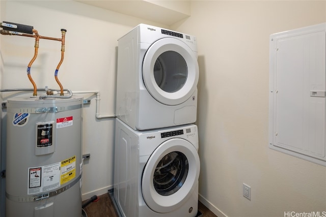 laundry area featuring secured water heater, electric panel, stacked washer and dryer, and dark wood-type flooring