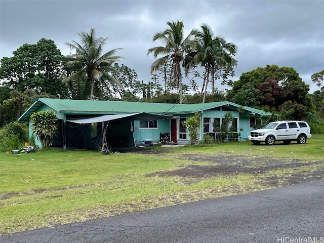 view of front of home featuring a front lawn and a carport