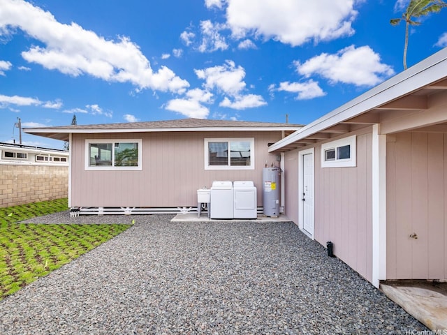 624 Olomana St, Kailua, HI 96734 - back of house featuring electric water heater, washer and clothes dryer, fence, a patio area, and a sink