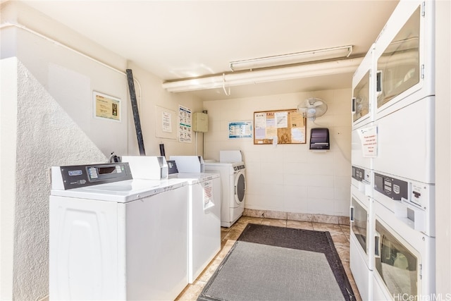 laundry area with washing machine and dryer and stacked washer / drying machine